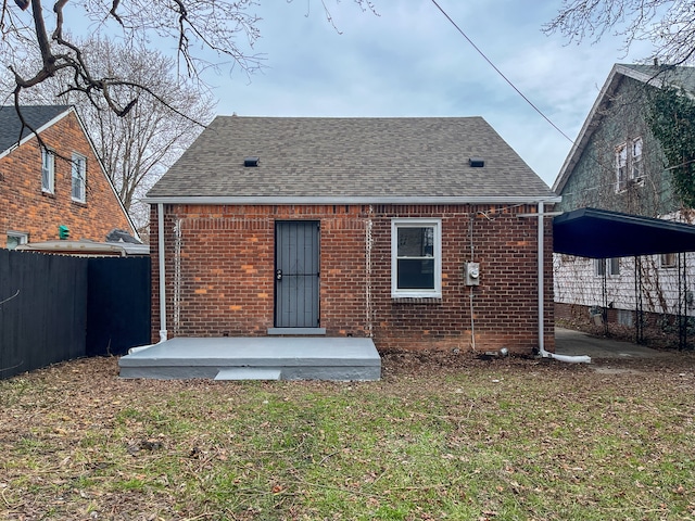 4651 Berkshire St, Detroit, MI 48224 - rear view of property with brick siding, fence, a shingled roof, and a lawn