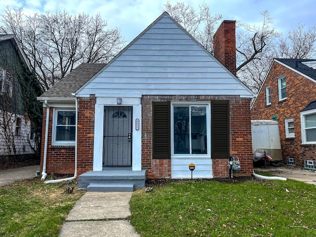 4651 Berkshire St, Detroit, MI 48224 - bungalow-style home featuring a front lawn, brick siding, and a chimney
