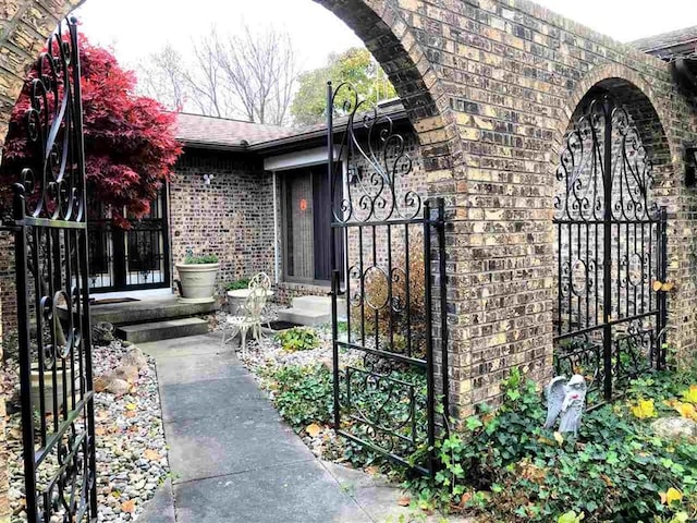 property entrance featuring brick siding