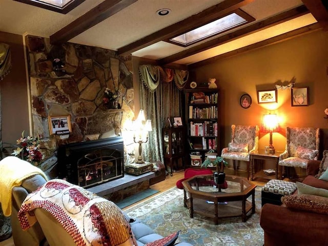 living room featuring beam ceiling and a skylight