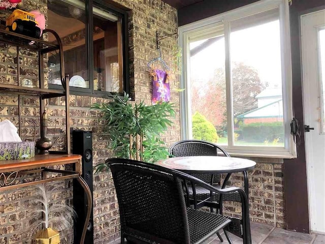 sunroom / solarium featuring outdoor dining area