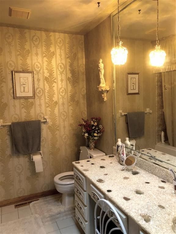 bathroom featuring toilet and tile patterned flooring