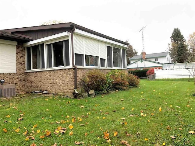 view of home's exterior with brick siding and central air condition unit