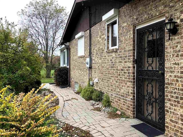 view of side of property with brick siding