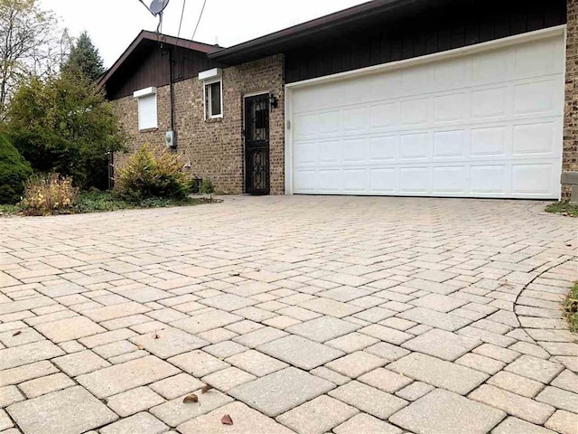 garage featuring decorative driveway