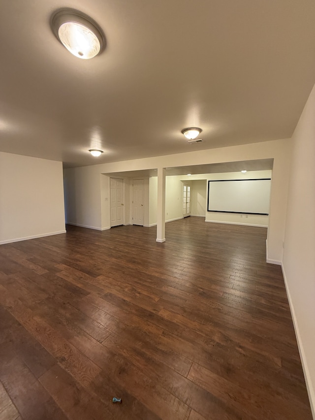 finished below grade area with dark wood-type flooring and baseboards