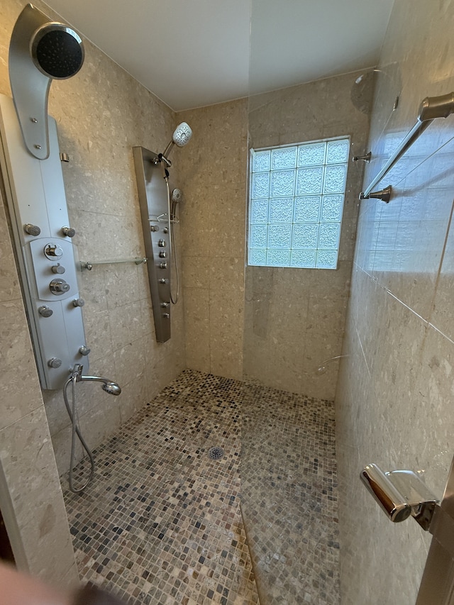 bathroom with a tile shower