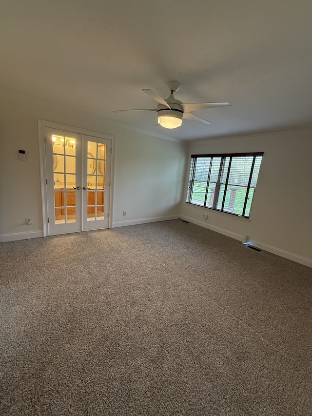 carpeted empty room with baseboards, a ceiling fan, french doors, and visible vents