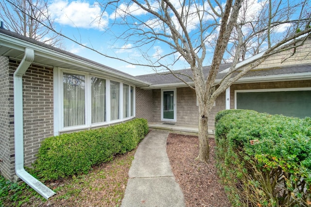 property entrance featuring brick siding