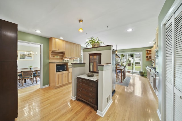 kitchen featuring light brown cabinetry, open shelves, visible vents, and black microwave