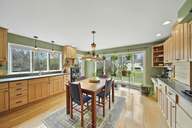 dining area with light wood-style flooring, recessed lighting, and beverage cooler