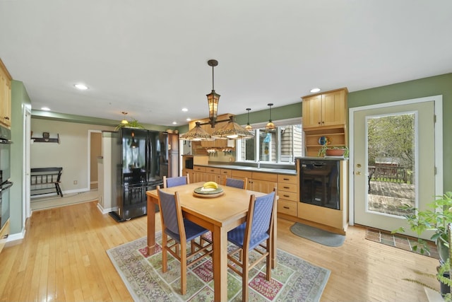 dining area featuring light wood-type flooring, baseboards, and recessed lighting