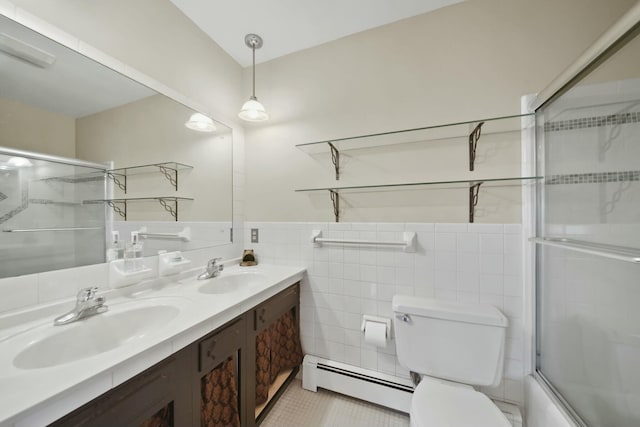 bathroom featuring toilet, a baseboard radiator, double vanity, and a sink
