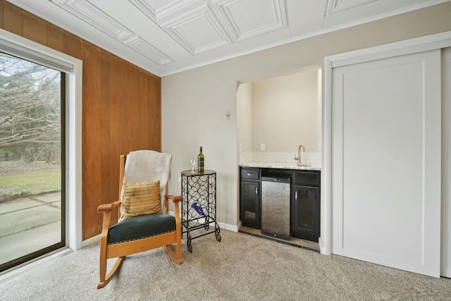 living area with carpet, wet bar, and ornamental molding