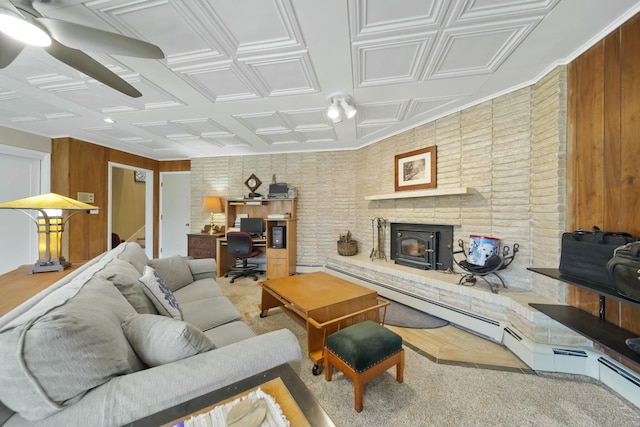 living area with an ornate ceiling and wood walls