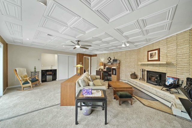 living room featuring carpet flooring, a ceiling fan, visible vents, an ornate ceiling, and a brick fireplace
