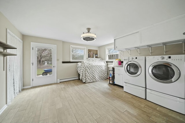 laundry area featuring laundry area, separate washer and dryer, baseboard heating, light wood finished floors, and baseboards