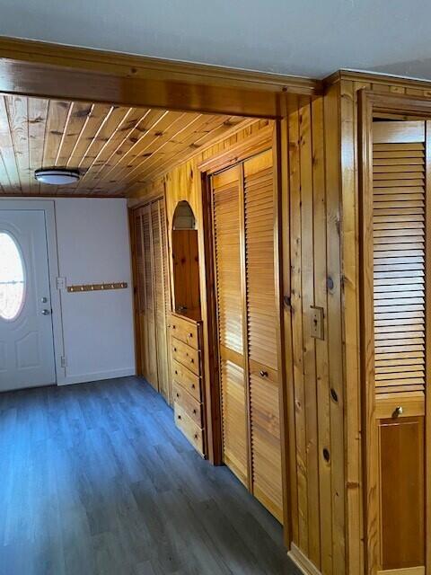 entryway featuring wood ceiling, wood finished floors, and wooden walls