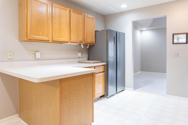 21329 Mulberry Ct, Farmington Hills, MI 48336 - kitchen featuring baseboards, a peninsula, light countertops, freestanding refrigerator, and light floors