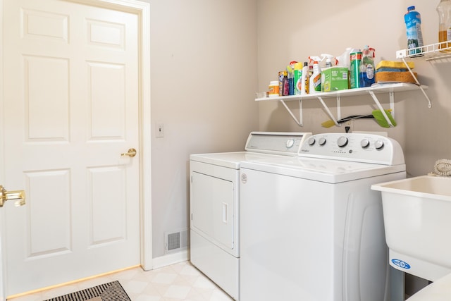 21329 Mulberry Ct, Farmington Hills, MI 48336 - washroom featuring visible vents, washer and dryer, a sink, laundry area, and light floors