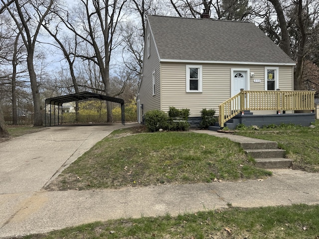 372 Creston St, Muskegon, MI 49442 - cape cod house with concrete driveway, a chimney, a detached carport, a shingled roof, and a front yard