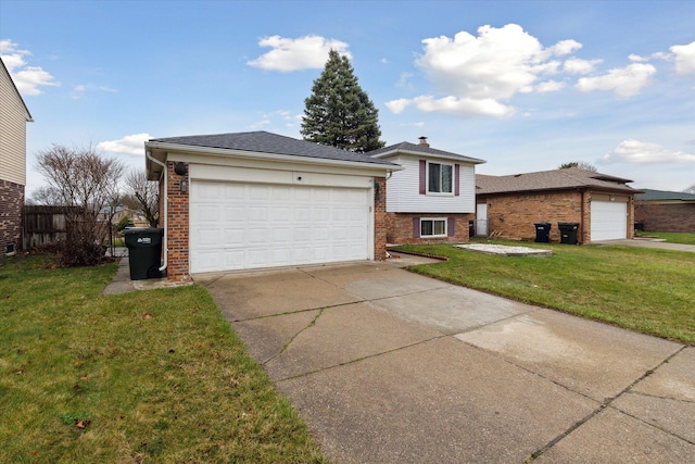split level home featuring a garage, a front yard, concrete driveway, and brick siding