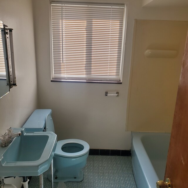 20209 Stotter St, Detroit, MI 48234 - full bathroom with baseboards, a sink, toilet, a tub to relax in, and tile patterned flooring