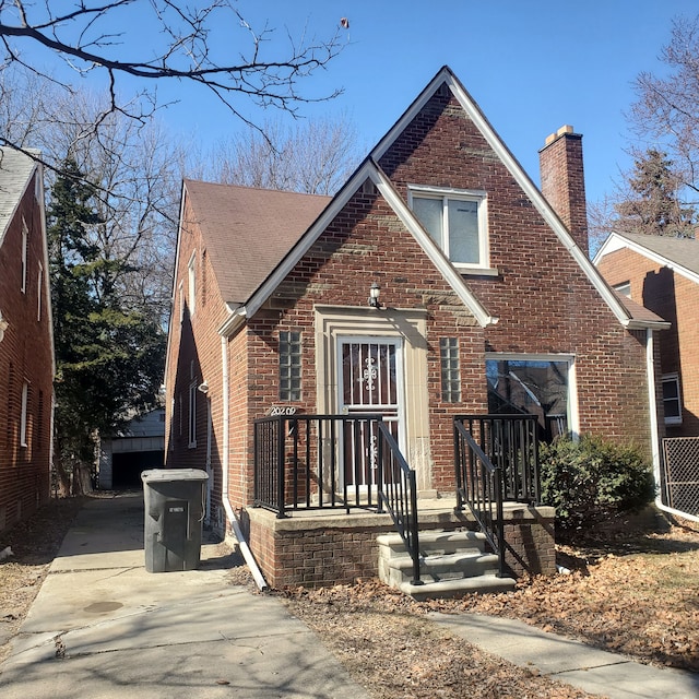 20209 Stotter St, Detroit, MI 48234 - view of front of home with a chimney, an outdoor structure, and brick siding