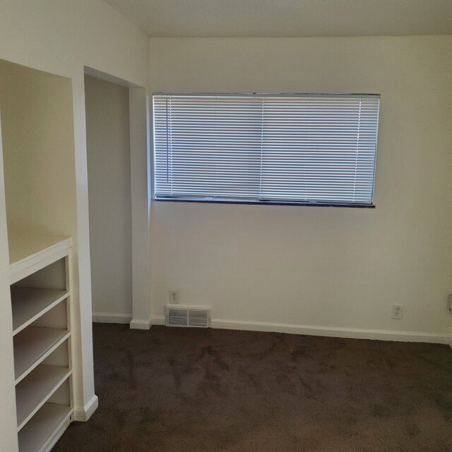 20209 Stotter St, Detroit, MI 48234 - unfurnished room with visible vents, baseboards, and dark carpet