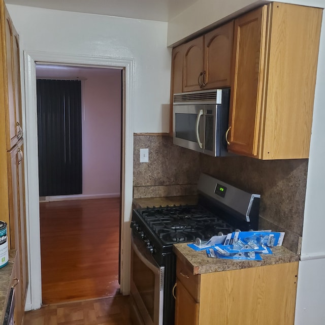 20209 Stotter St, Detroit, MI 48234 - kitchen featuring tasteful backsplash, appliances with stainless steel finishes, and wood finished floors