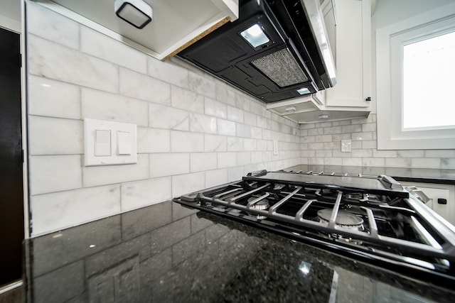 6522 Ellinwood Dr, White Lake, MI 48383 - kitchen with stovetop, tasteful backsplash, white cabinets, and ventilation hood
