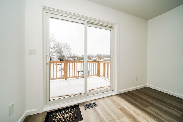 6522 Ellinwood Dr, White Lake, MI 48383 - entryway with wood finished floors, baseboards, and visible vents