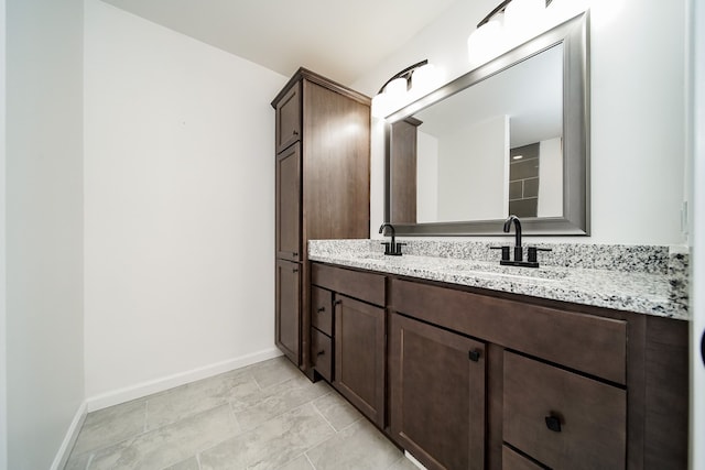 6522 Ellinwood Dr, White Lake, MI 48383 - full bath with double vanity, baseboards, and a sink
