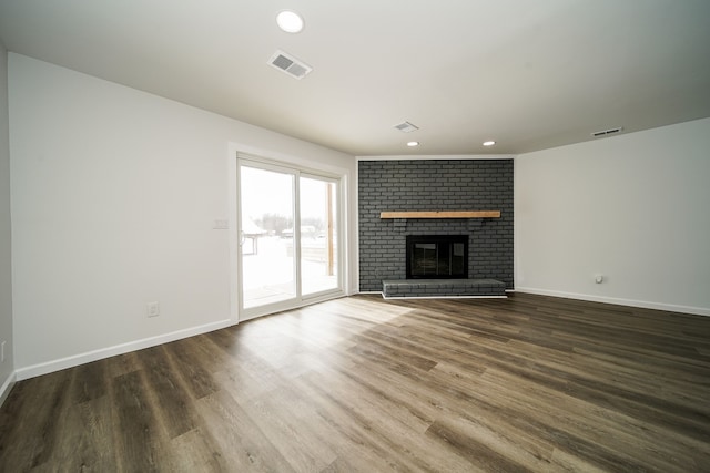 6522 Ellinwood Dr, White Lake, MI 48383 - unfurnished living room with wood finished floors, a fireplace, visible vents, and recessed lighting