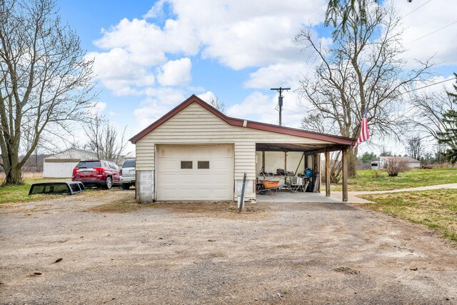 6357 Baldwin Rd, Swartz Creek, MI 48473 - garage featuring a garage and dirt driveway