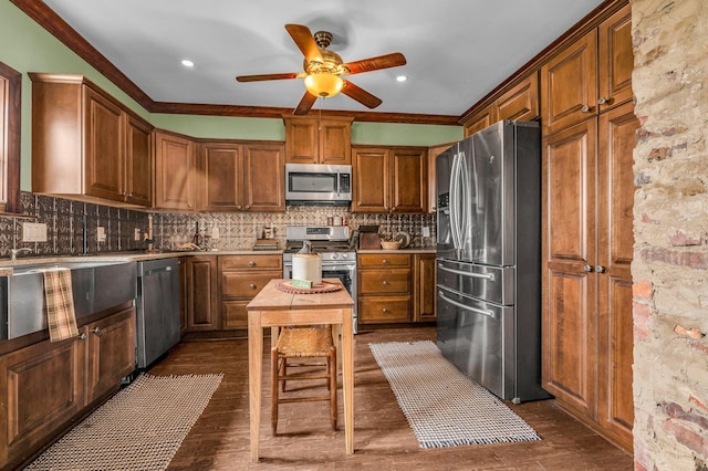 6357 Baldwin Rd, Swartz Creek, MI 48473 - kitchen featuring ornamental molding, a ceiling fan, appliances with stainless steel finishes, dark wood-style flooring, and backsplash