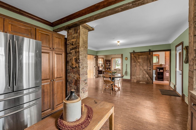 6357 Baldwin Rd, Swartz Creek, MI 48473 - kitchen featuring a barn door, ornamental molding, freestanding refrigerator, brown cabinets, and wood finished floors