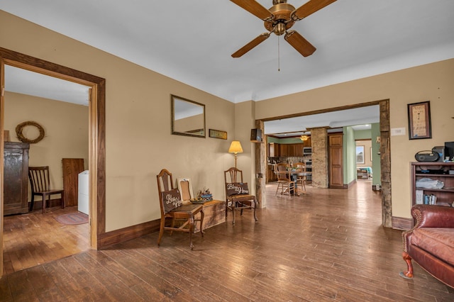6357 Baldwin Rd, Swartz Creek, MI 48473 - living area with decorative columns, baseboards, hardwood / wood-style floors, and ceiling fan