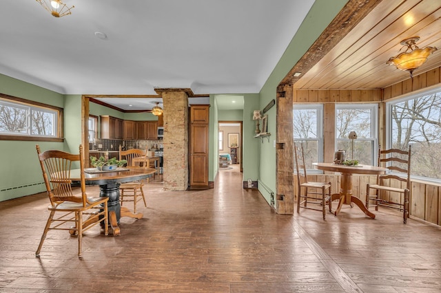 6357 Baldwin Rd, Swartz Creek, MI 48473 - dining space featuring hardwood / wood-style floors, a baseboard radiator, and a wealth of natural light