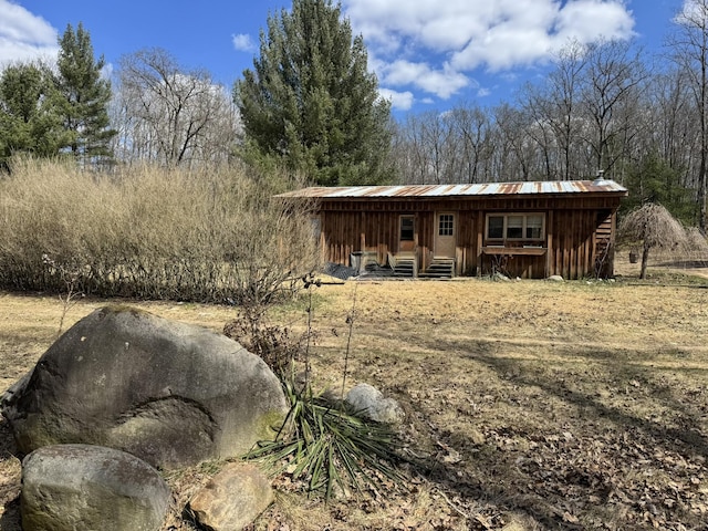 back of property with metal roof