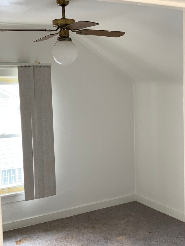 carpeted empty room with baseboards, a ceiling fan, and lofted ceiling