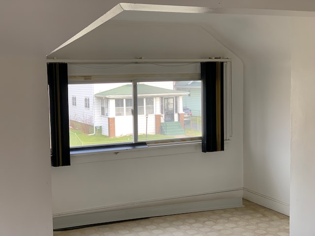 unfurnished room with baseboards, light floors, and baseboard heating