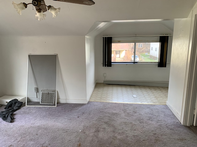 interior space with baseboards, a ceiling fan, and carpet floors