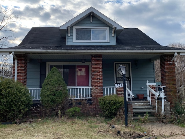 bungalow featuring brick siding and covered porch