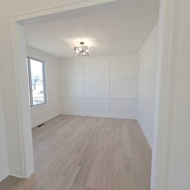 18468 Stallmann Dr, Macomb, MI 48042 - spare room featuring light wood-type flooring, a chandelier, baseboards, and ornamental molding