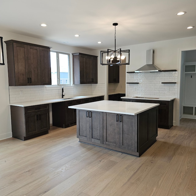 18468 Stallmann Dr, Macomb, MI 48042 - kitchen featuring wall chimney exhaust hood, decorative backsplash, light wood finished floors, cooktop, and recessed lighting