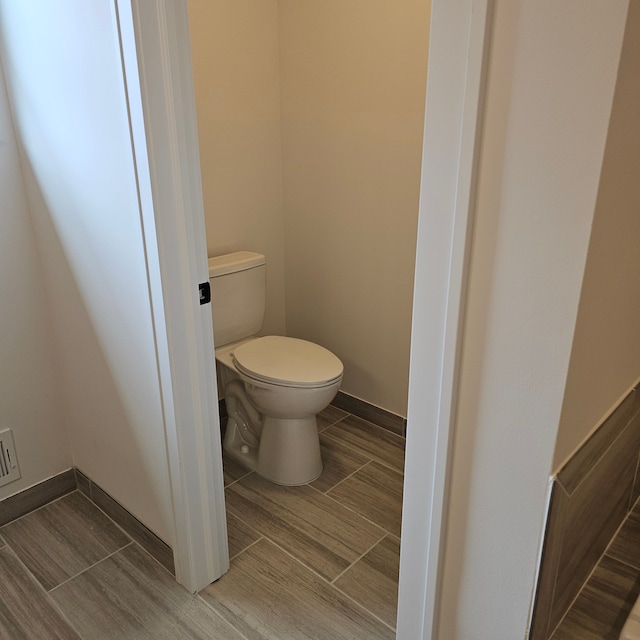 18468 Stallmann Dr, Macomb, MI 48042 - bathroom with toilet and wood tiled floors