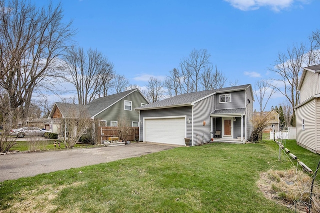 traditional home with fence, a shingled roof, driveway, a front yard, and an attached garage