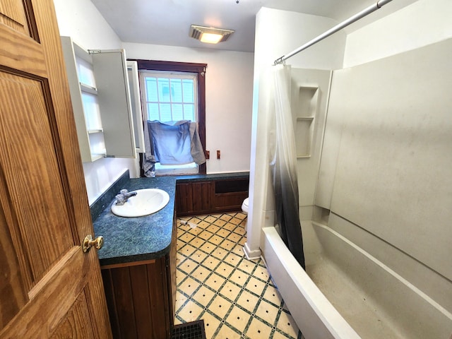 bathroom featuring toilet, tile patterned floors, shower / bathtub combination with curtain, and vanity