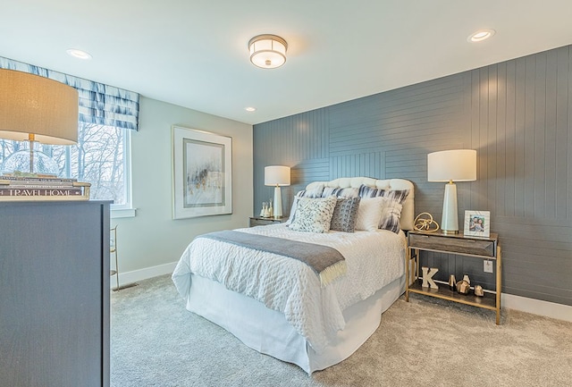 carpeted bedroom featuring wooden walls, baseboards, and recessed lighting